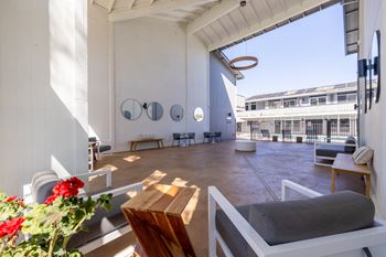 A living area with a couch and a table and a large window